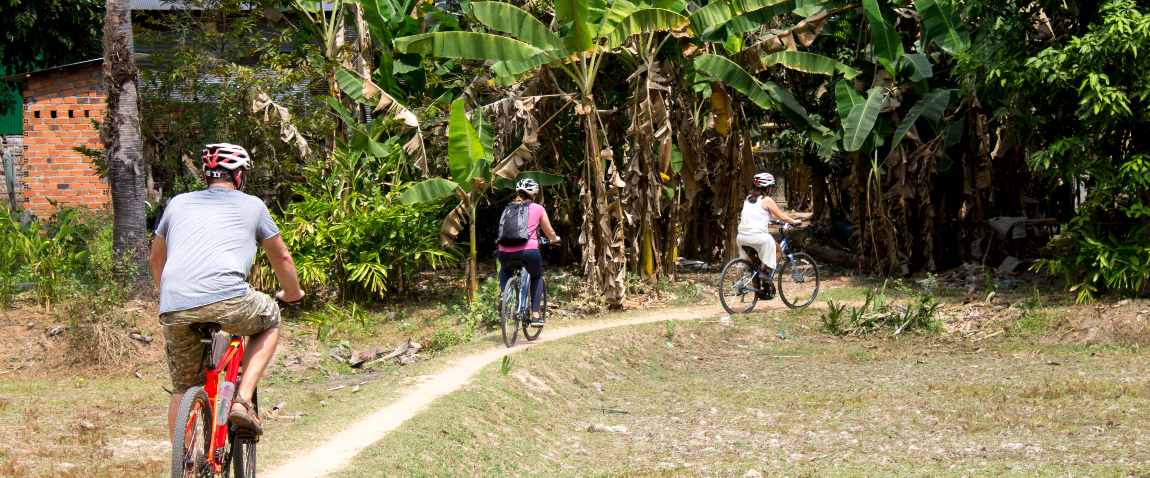 cyclists ride along trail leading
